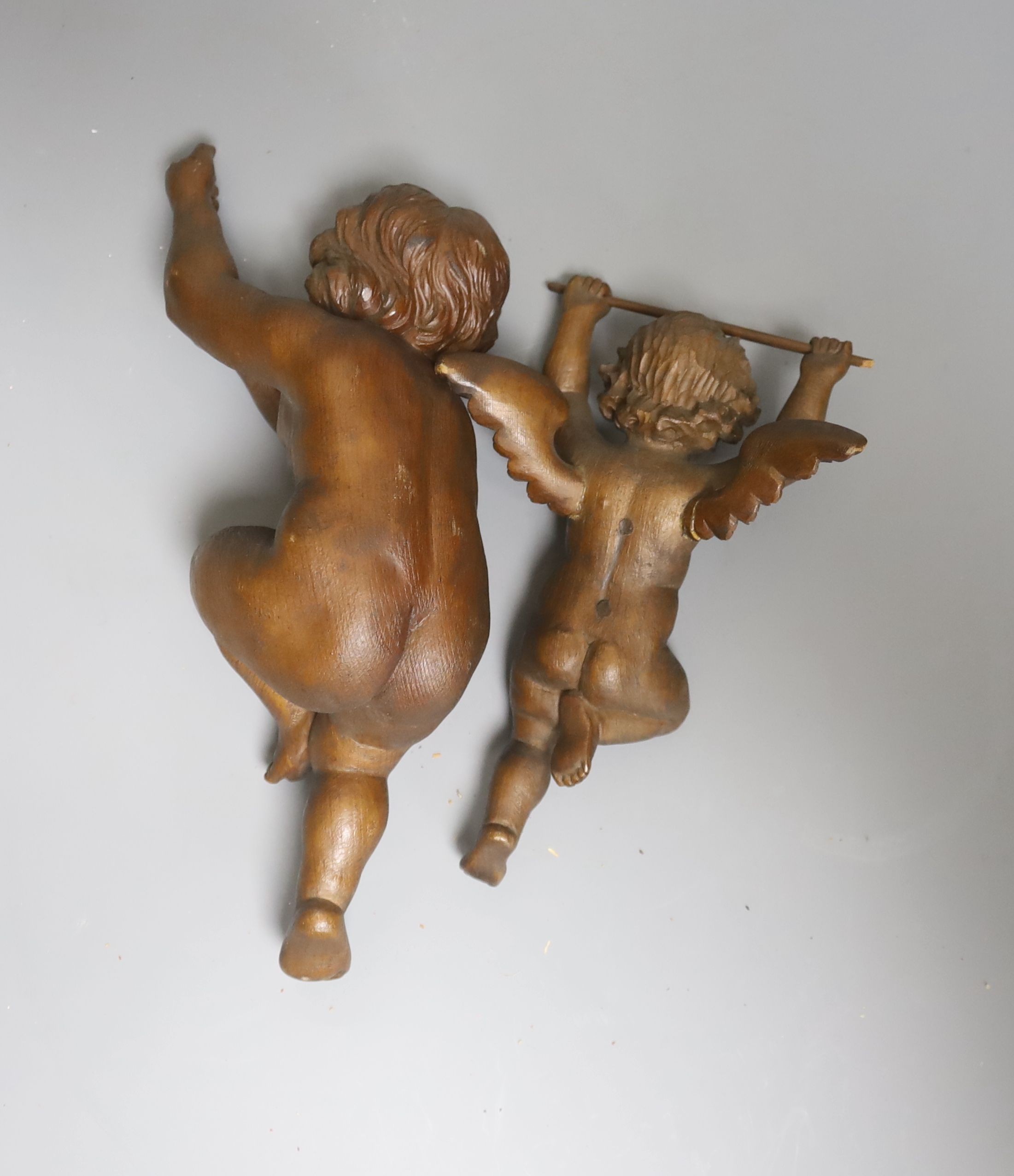 Two carved beech figures of cherubs 27cm